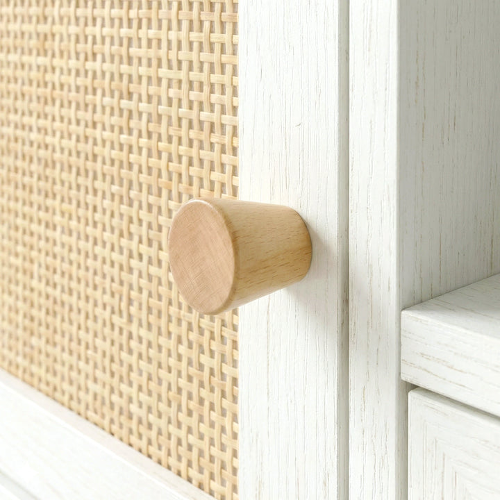 [White] Wovena Rattan TV Unit close-up of woven cane panel, natural wooden knob, and white wood-grain finish on the door