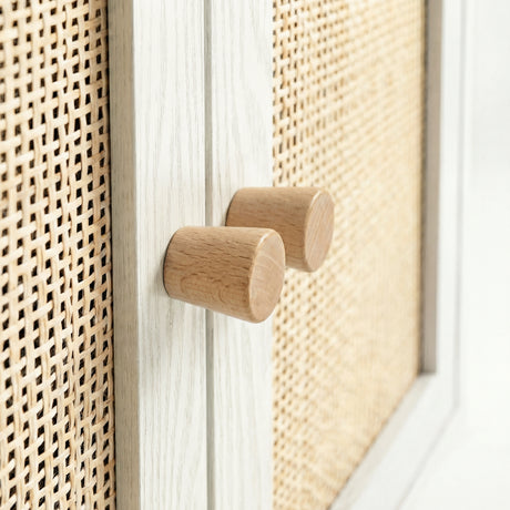 [White] Wovena close-up of two solid cylindrical oak knob handles set side by side on the whitewashed centre door frame with rattan panels flanking