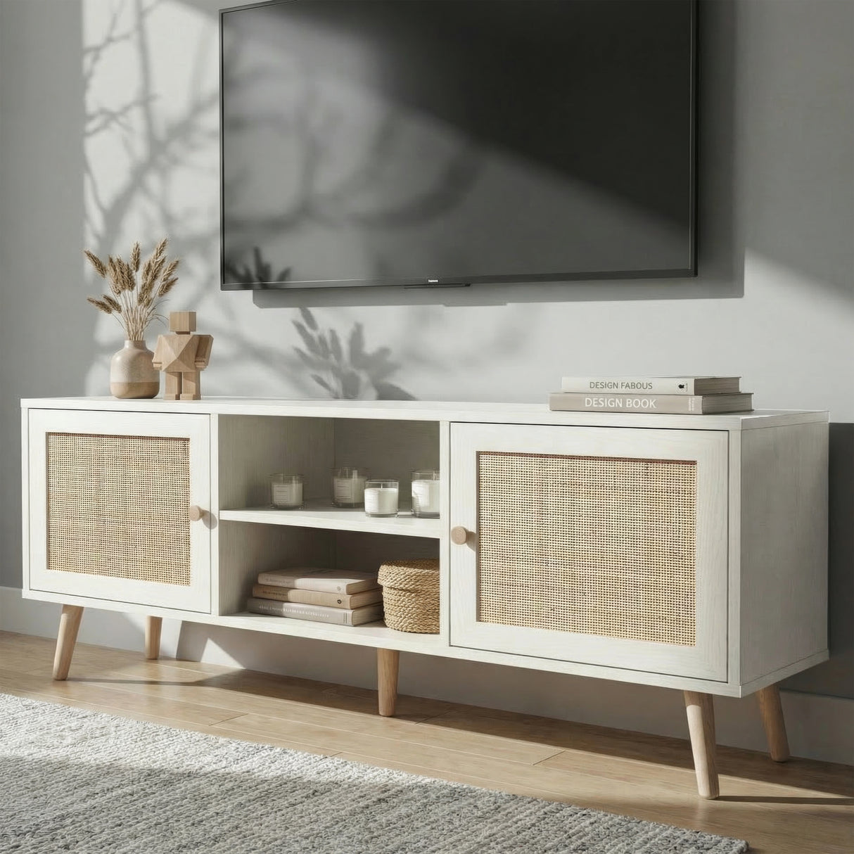 [White] Wovena lifestyle angled view with dried pampas, stacked books, and woven basket beneath a wall-mounted TV