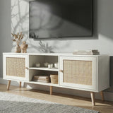 [White] Wovena lifestyle angled view with dried pampas, stacked books, and woven basket beneath a wall-mounted TV