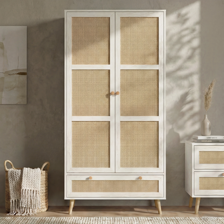 [White] Wovena wardrobe front view with rattan panelled 2 doors and base drawer styled against a warm grey wall