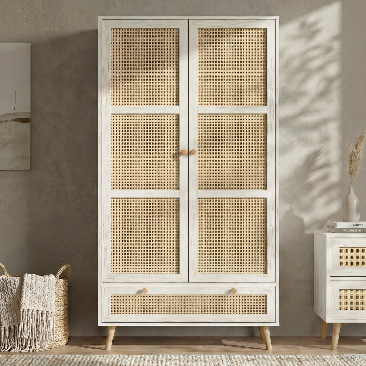 [White] Wovena wardrobe front view with rattan panelled 2 doors and base drawer styled against a warm grey wall