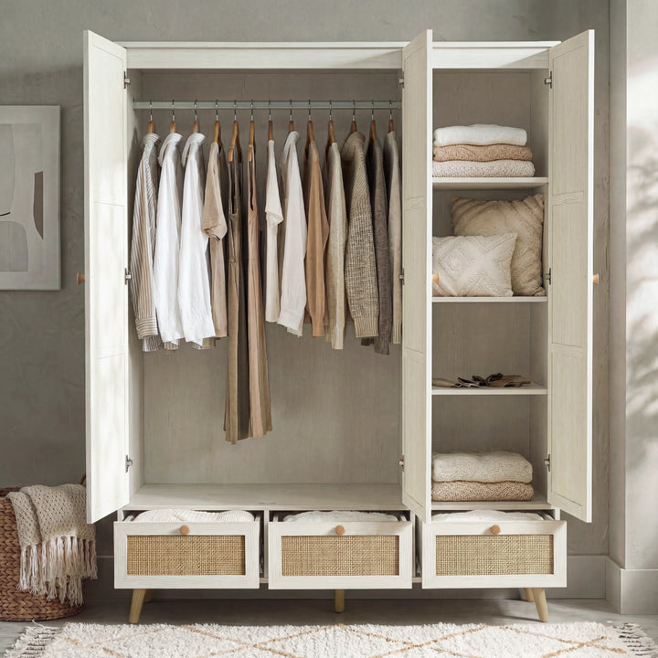 [White] Wovena 3 door wardrobe open showing left hanging rail with garments and right shelves of folded knitwear