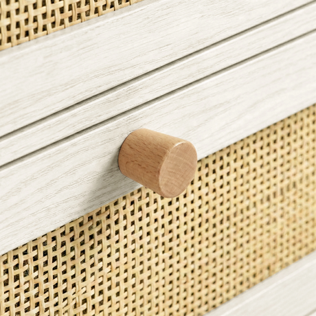 [White] Wovena wardrobe detail showing cylindrical wooden knob set against oak wood grain and natural rattan weave texture