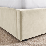 [Beige | King] Close-up of padded footboard corner showing plush fabric and Elevated bed base detail