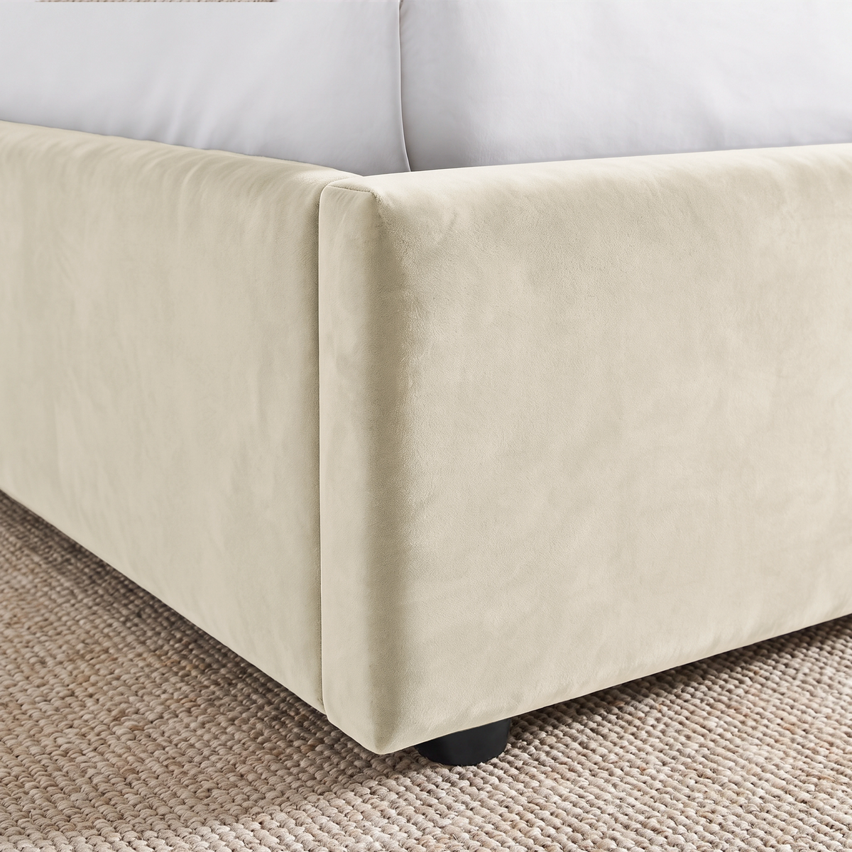 [Beige | King] Close-up of padded footboard corner showing plush fabric and Elevated bed base detail