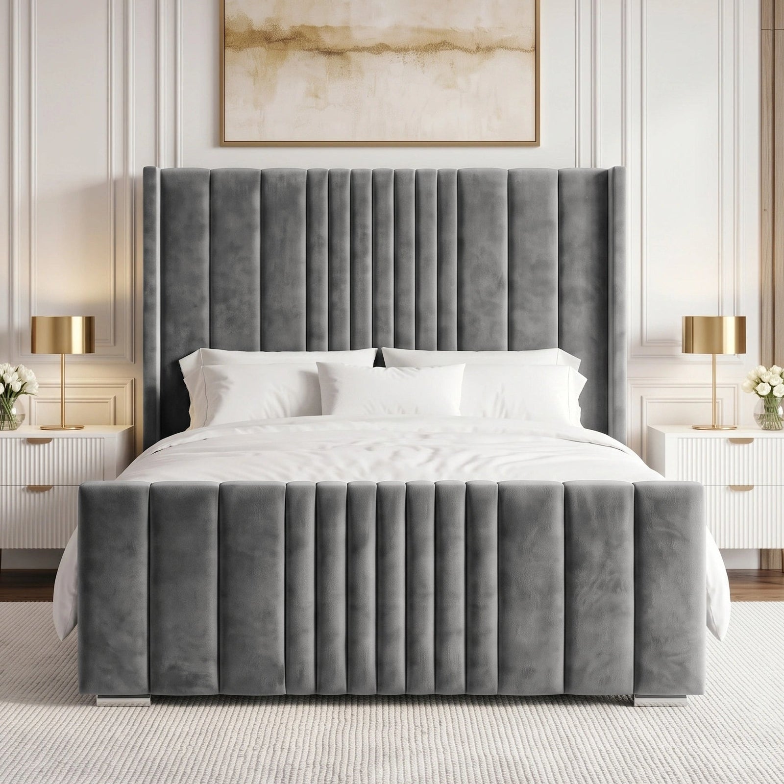 [King | Grey] velvet bed frame with a tall, channel-tufted headboard and matching footboard, styled in a contemporary bedroom with white bedding, white nightstands, gold lamps, and a neutral wall paneling.