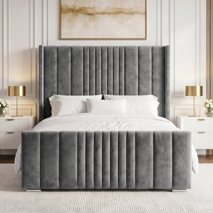 [King | Grey] velvet bed frame with a tall, channel-tufted headboard and matching footboard, styled in a contemporary bedroom with white bedding, white nightstands, gold lamps, and a neutral wall paneling.