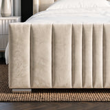 [Double | Beige] Close-up of matching vertical channel-stitched footboard with brass feet on textured rug