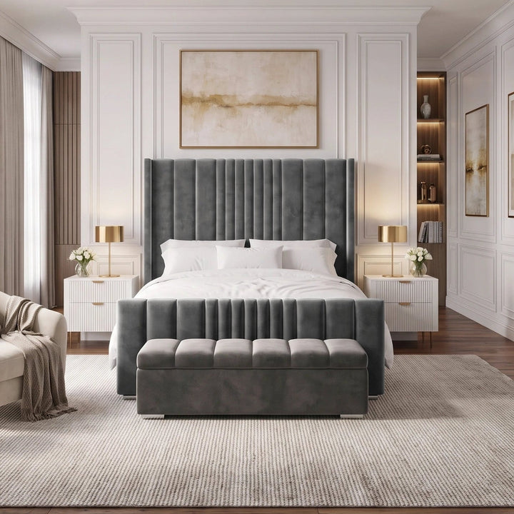 [King | Grey] An upholstered bed frame in a grey fabric, styled with white bedding, pillows, and a beige throw blanket in a modern bedroom setting.