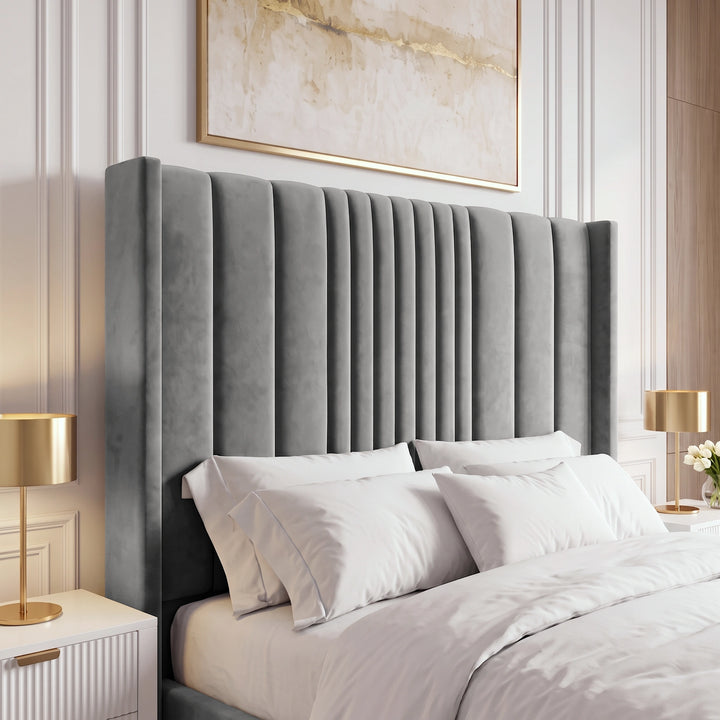 [King | Grey] upholstered headboard in textured gray velvet, styled on a bed with white bedding and pillows in a modern bedroom setting with gold bedside lamps and a gold-framed painting.