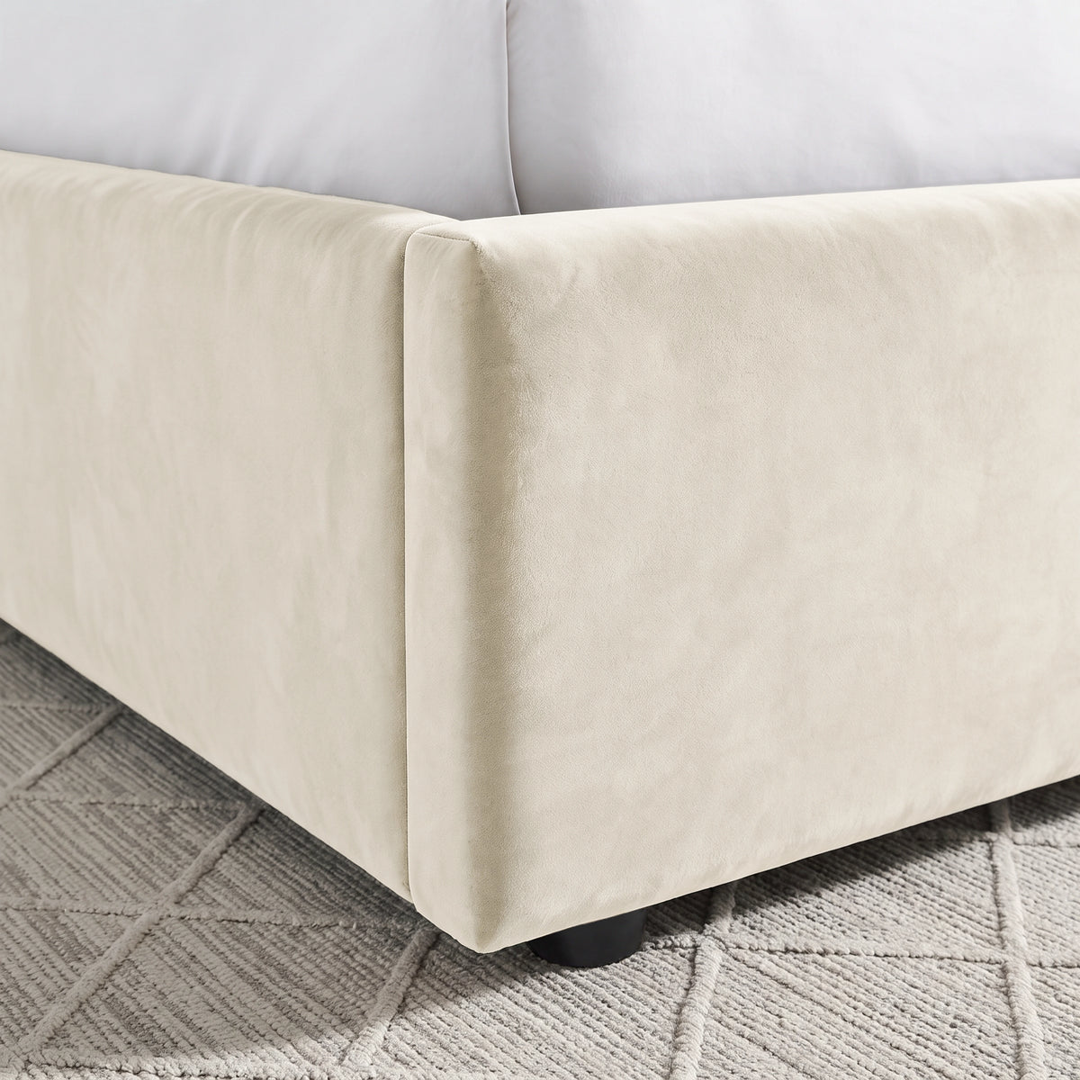 [Beige | Double] Close-up of padded footboard corner showing plush fabric and Elevated bed base detail