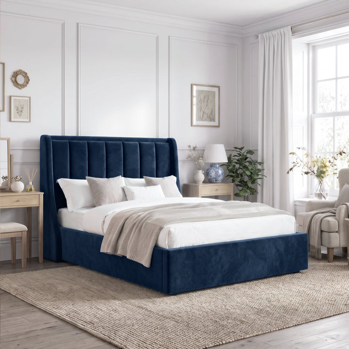 [Blue | Double] Winged ottoman storage bed angled room view with winged vertical panel headboard and bedding