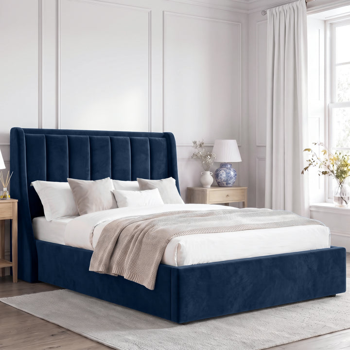 [Blue | Double] Winged ottoman storage bed angled room view with winged vertical panel headboard and bedding