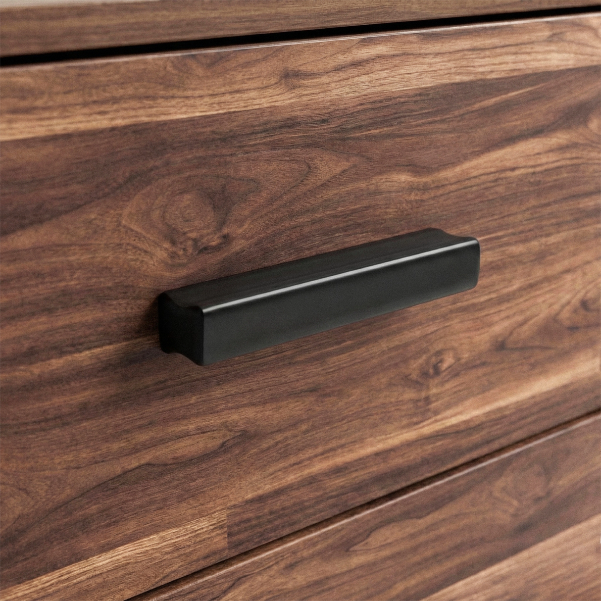 [Dark Bronx] Close up of wood rustic drawer front with matte black horizontal handle and textured grain surface