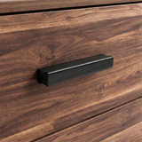 [Dark Bronx] Close up of wood rustic drawer front with matte black horizontal handle and textured grain surface
