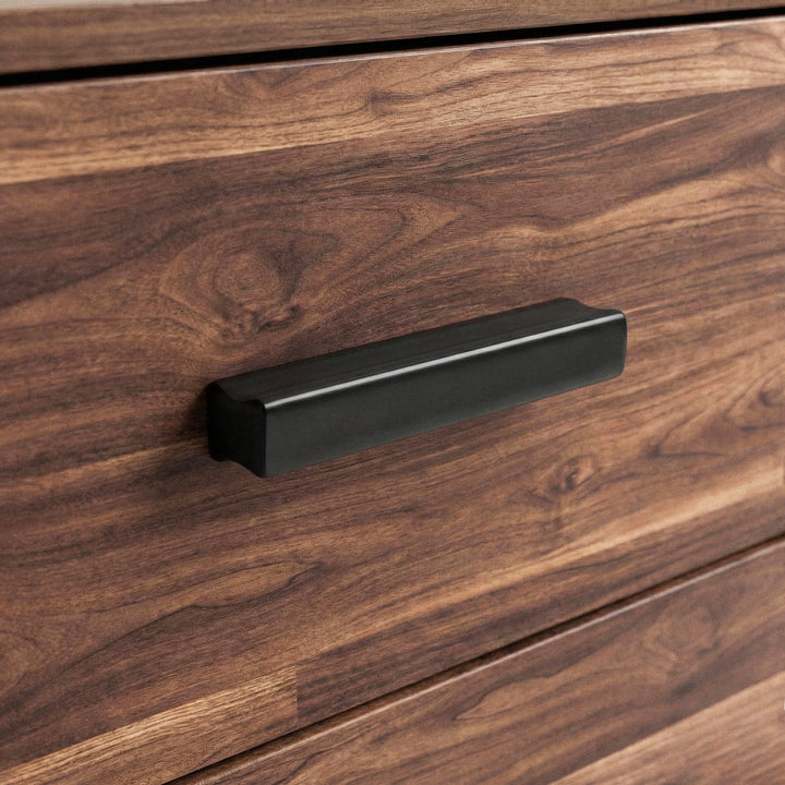 [Dark Bronx] Close up of wood rustic drawer front with matte black handle and textured grain surface