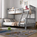 Children's bedroom with a gray and white bunk bed, toys, and a colorful rug.