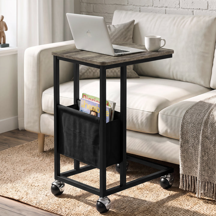 [Wooden Grey] C-shaped side table by sofa with wooden grey-effect top, black frame, pouch, laptop and ball caster wheels