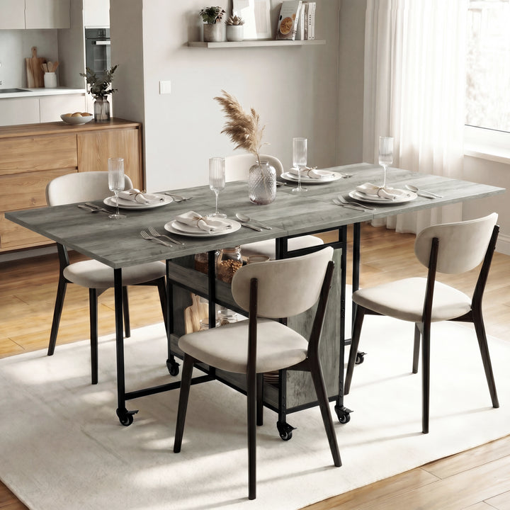 [Wooden Grey] Stovra dining scene with grey wood table surface, black frame, storage shelves, and caster wheels.
