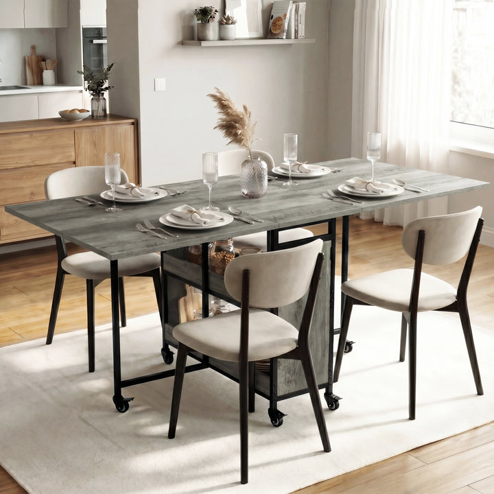 [Wooden Grey] Stovra dining scene with grey wood table surface, black frame, storage shelves, and caster wheels.