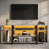 [Wooden Grey] Zelumi TV stand front-facing against a concrete wall with warm yellow LED shelves, consoles, VR headset, game cases and decorative items on top