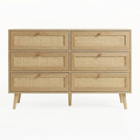 [Oak] Wovena wide chest front view showing full 2x3 rattan drawer grid, hardwood knobs, and splayed legs
