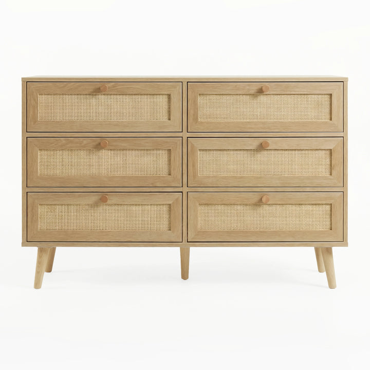 [Oak Effect] Wovena wide chest front view showing full 2x3 rattan drawer grid, hardwood knobs, and splayed legs