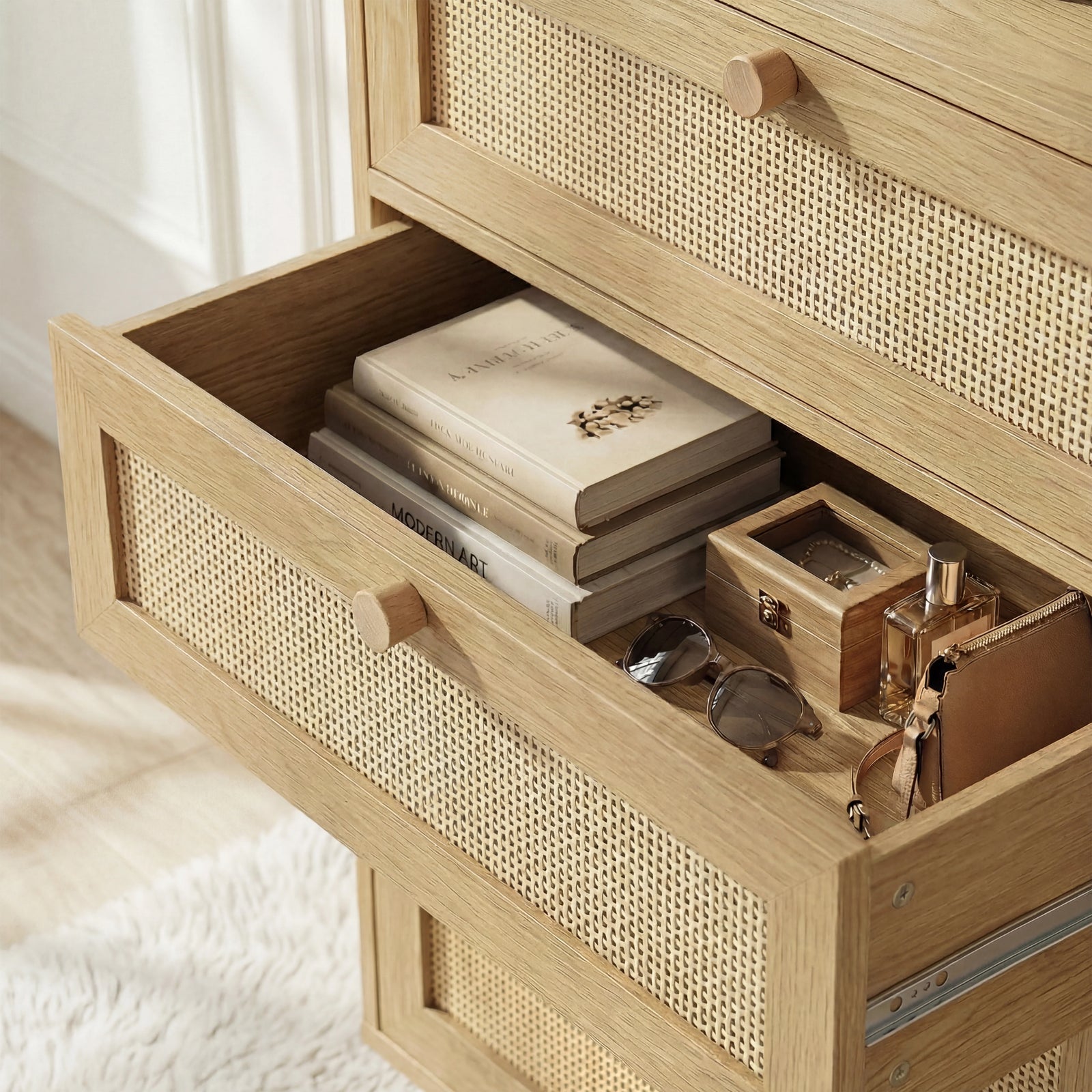 [Oak Effect] Top drawer Wovena rattan wide 6 chest of drawers pulled open showing folded knitwear and accessories