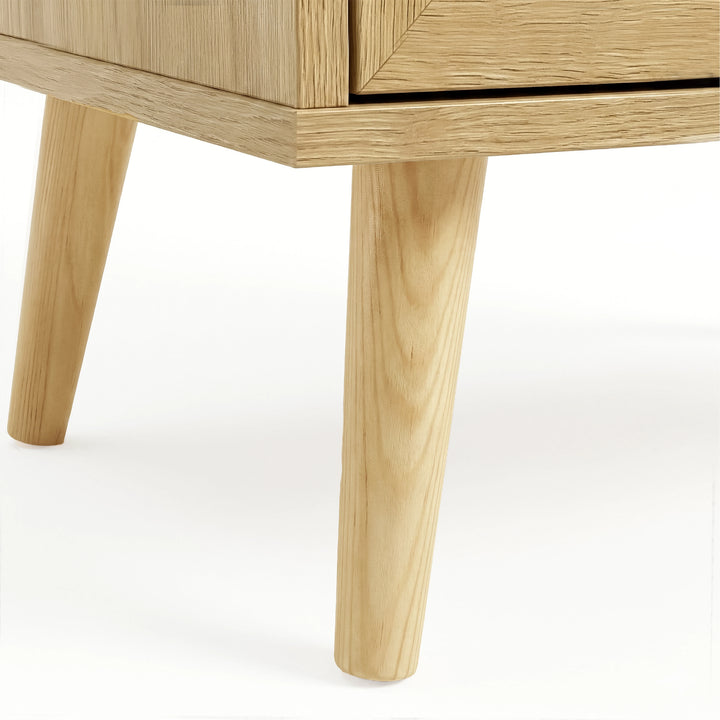 [Oak Effect] Wovena close-up of angled splayed pine leg with visible wood grain supporting the wide chest frame