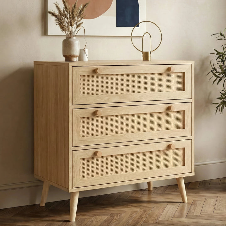 [Oak Effect] Wovena rattan chest of drawers at three-quarter angle in styled room with herringbone floor and wall art