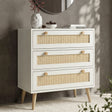 [White] Wovena chest of 3 drawers in a styled room with dark textured wall, round mirror, vase and books on top