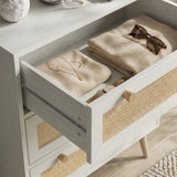 [White] Wovena chest of 3 drawers detail showing open top drawer with folded clothing, necklace, watch and sunglasses inside
