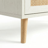 [White] Wovena rattan chest leg close-up, tapered natural pine leg meeting white carcass corner
