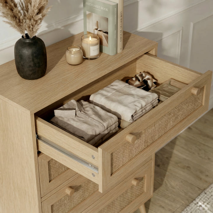 [Oak Effect] Top drawer detail of Wovena rattan bedroom furniture set chest, books and candles on oak top
