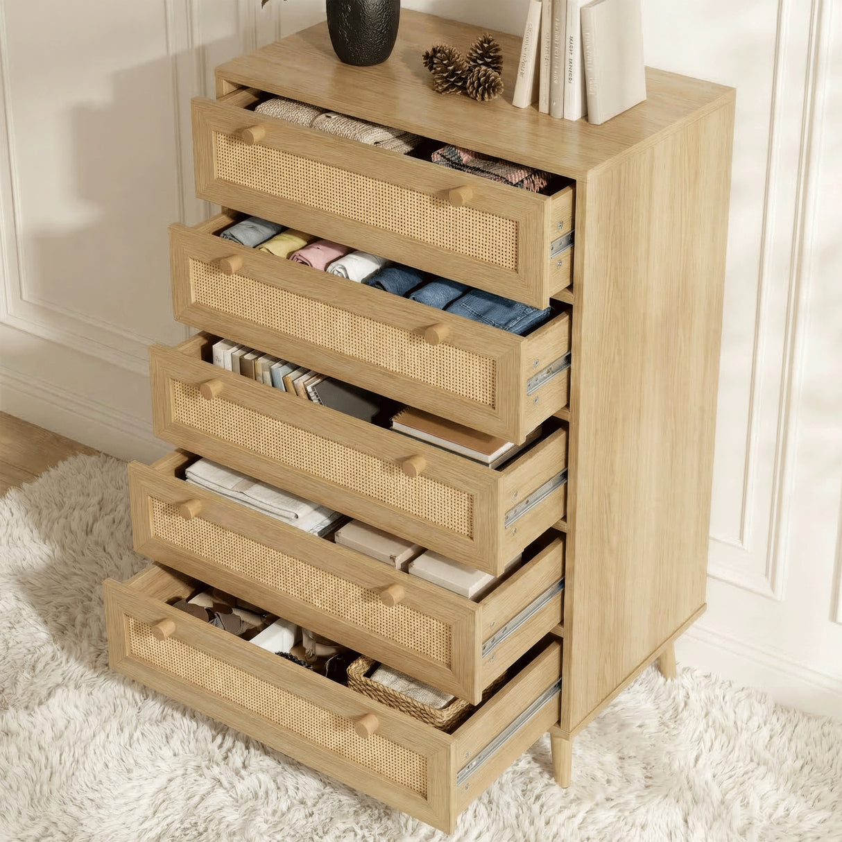 [Oak] 5 drawer chest fully open revealing storage across all levels with vase and books on top