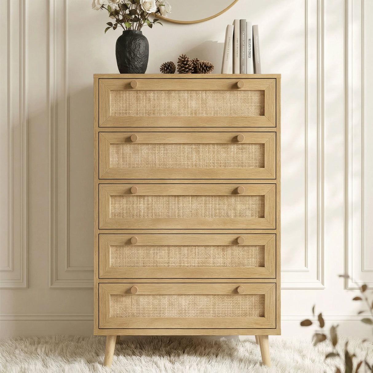 [Oak] Wovena 5 drawer rattan chest styled with vase of flowers books and pinecone against moulded wall