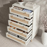 [White] Wovena rattan tallboy chest fully open from above, cane drawers staggered out exposing storage capacity