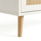 [White] Wovena rattan tallboy chest base view: angled pine leg meeting white carcass and woven cane front
