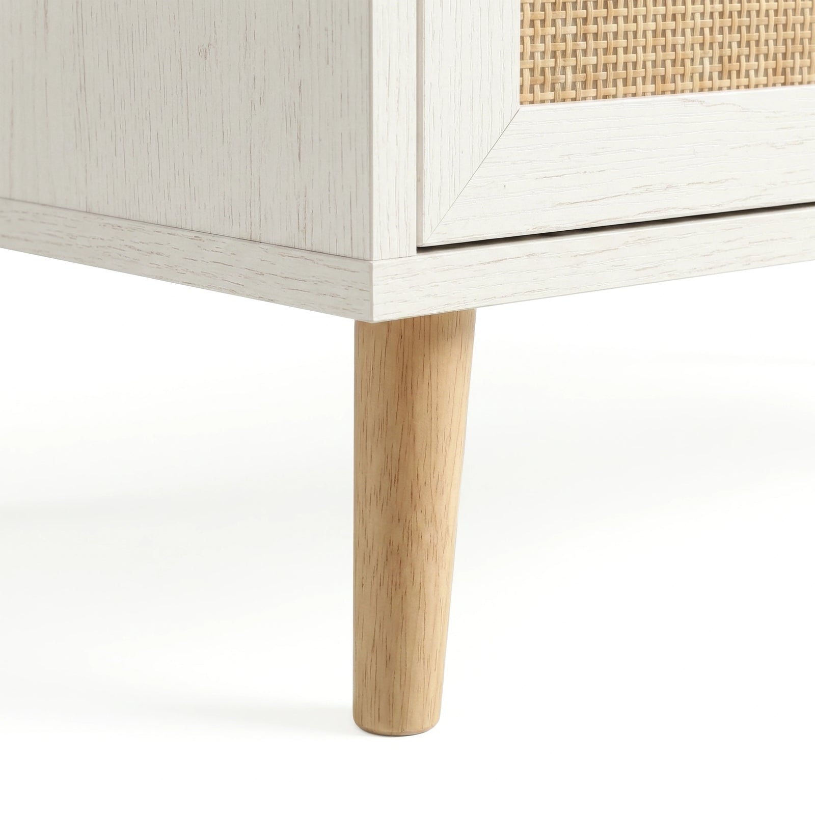 [White] Wovena rattan tallboy chest base view: angled pine leg meeting white carcass and woven cane front