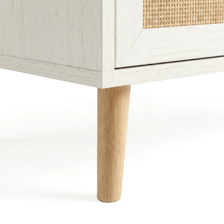 [White] Wovena rattan tallboy chest base view: angled pine leg meeting white carcass and woven cane front