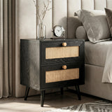 [Black] Wovena rattan bedside table beside bed with vase of stems and round clock on top