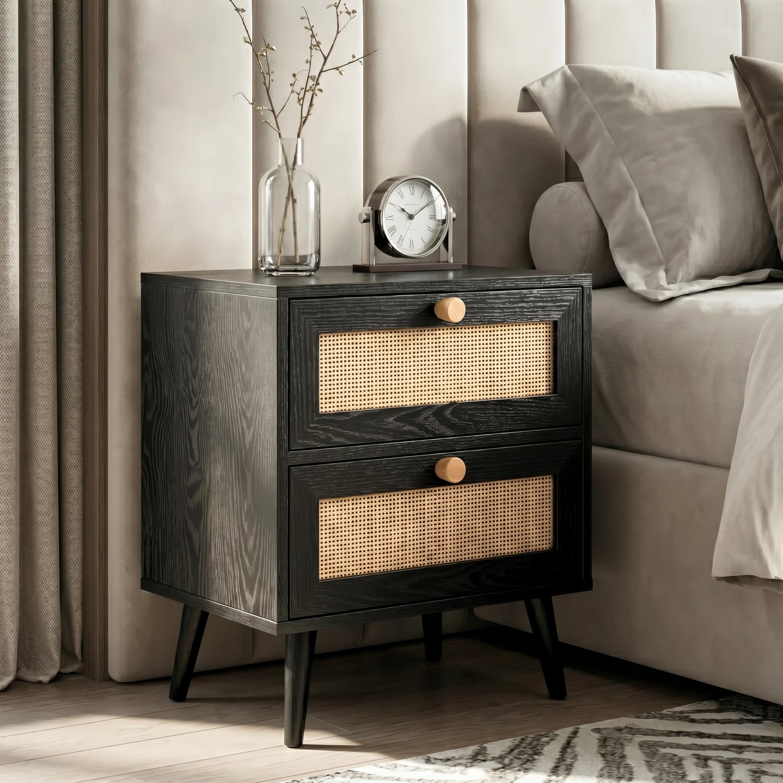 [Black] Wovena rattan bedside table beside bed with vase of stems and round clock on top