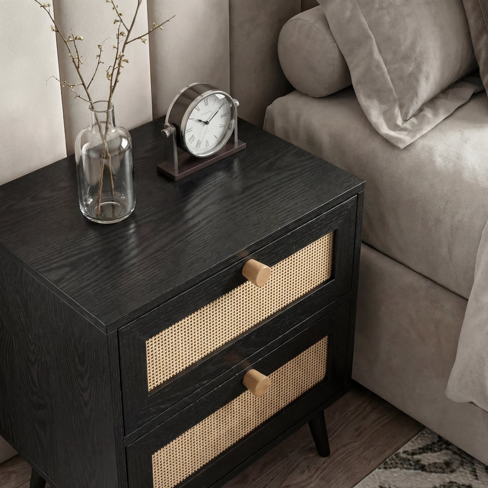 [Black] Wovena rattan bedside side angle next to grey sofa showing cane weave drawers and timber knobs