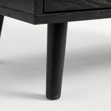 [Black] Detail of Wovena rattan bedside angled leg attached to cabinet, dark grain on leg and body