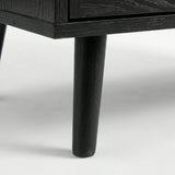 [Black] Detail of Wovena rattan bedside angled leg attached to cabinet, dark grain on leg and body