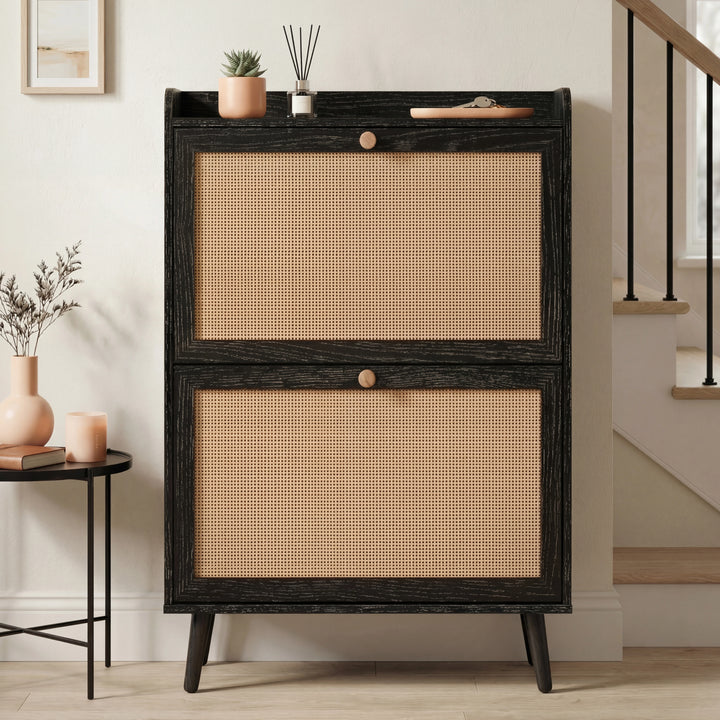 [Black] Wovena Rattan Black 2 Door Shoe Storage Cabinet front-facing in neutral hallway with black balustrade staircase and round black side table alongside