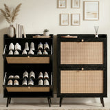 [Black] Wovena Rattan Black 2 Door Shoe Storage Cabinet close and open split view showing two flip-out drawers loaded with trainers against neutral wall with gallery prints