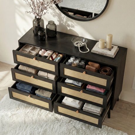 [Black] Wovena rattan chest with all six drawers pulled open showing folded clothes, belts and accessories inside