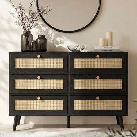 [Black] Wovena rattan chest front view in styled bedroom with round mirror, dried branches in vase and pillar candles on top